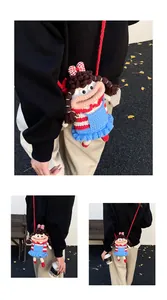 Detail of handmade crochet doll crossbody bag with stripe knit texture and cute design