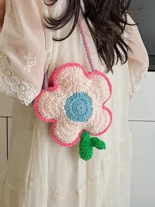 Handmade crochet flower crossbody bag with colorful yarn knitting in soft pastel tones