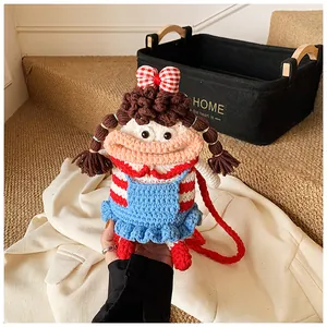 Detail of handmade crochet doll bag featuring colorful yarn textures and woven strap