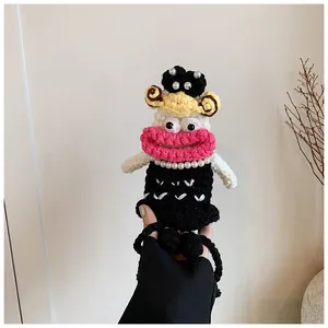 Close-up of handmade crochet mini bag with big pink lips and pearl necklace detail
