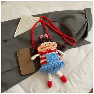 Close-up of handmade crochet doll bag showing intricate knit texture and a cute bow