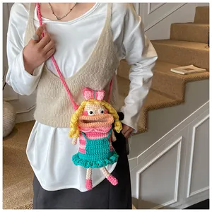 Detail of colorful crochet doll shoulder bag worn by model on a modern staircase