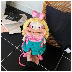 Detail of handmade crochet doll crossbody bag showing intricate yarn texture and doll face