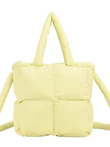 Quilted puffer tote bag in pale yellow with dual handles and crossbody strap
