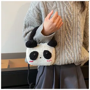 Detailed knit texture of a cute panda crochet crossbody bag with 3D ears and eyes