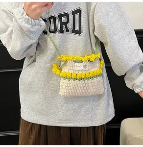 Detalle de bolso de ganchillo hecho a mano con flores amarillas y etiqueta decorativa