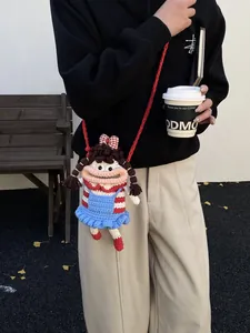 Cute crochet doll crossbody bag with pigtails for women, autumn outdoor photoshoot style