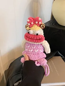 Handmade crochet doll bag featuring yellow curly hair and pearl necklace accessory