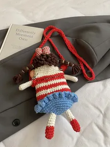 Handmade crochet doll crossbody bag with red stripes and blue ruffled skirt for women