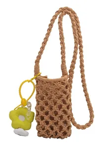 Handmade macrame mini crossbody phone bag in khaki with a yellow flower charm pendant