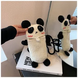 Close-up of handmade crochet panda bag with 3D ears and intricate knit texture