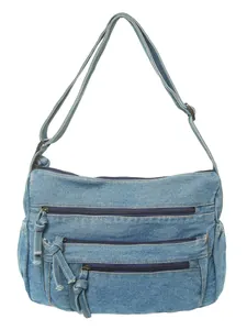 Vintage light blue washed denim crossbody bag with multiple front zipper pockets and strap