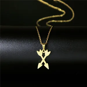 Minimalist gold stainless steel necklace with crossed arrows pendant on black background