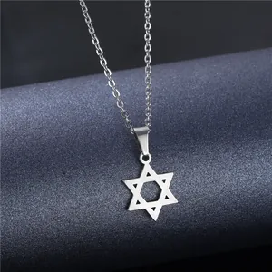Polished stainless steel hexagram pendant necklace on a blue textured pedestal