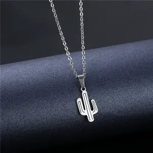Minimalist stainless steel cactus pendant necklace with a fine chain on a dark background
