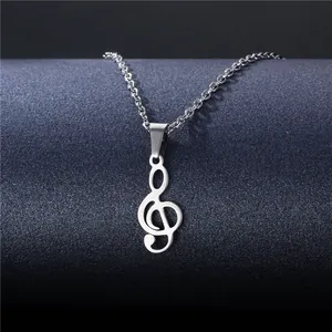 Polished stainless steel treble clef musical note pendant necklace on a grey display stand