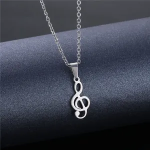 Polished stainless steel G-clef musical note pendant necklace on dark textured display
