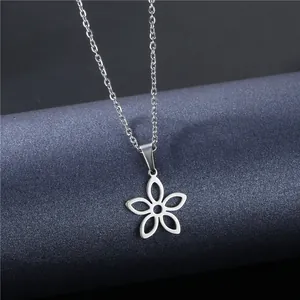 Sleek silver stainless steel necklace with a hollow flower pendant on a dark blue stand