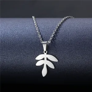 Silver hollow leaf pendant necklace made of stainless steel on dark textured background