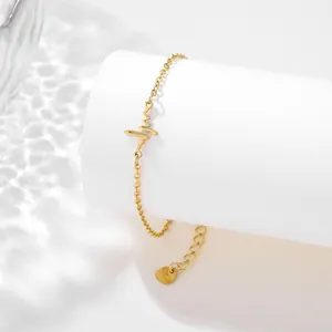 Detailed shot of golden heartbeat bracelet with adjustable chain on white podium