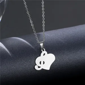 Polished stainless steel treble clef heart necklace for music lovers on dark background