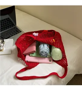 Detail view of red crochet tote bag interior showing ample space for iPad and essentials