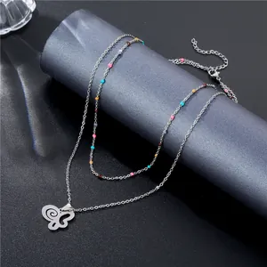 Double layered silver butterfly necklace with colorful beads on a premium display stand