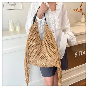 Detailed close-up of Bohemian woven cotton tote with fringe trim and leather strap