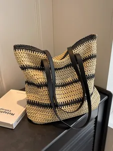 Bohemian striped straw tote bag with black faux leather shoulder straps for beach commute