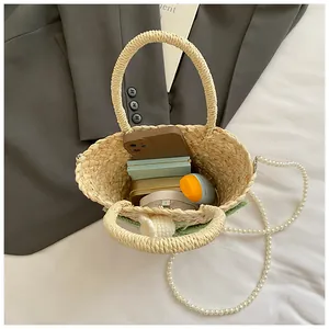 Detailed interior view of woven straw bag showing storage capacity for phone and cosmetics
