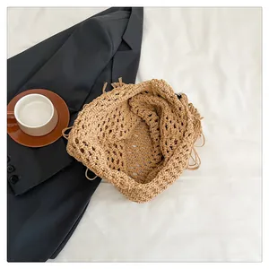 Detailed macro view of bohemian hand-woven cotton beach tote with tassel fringes