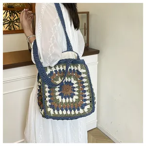 Detail view of a bohemian granny square crochet tote bag with colorful sunburst patterns