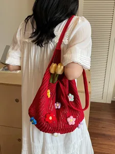 Red knit tote bag with 3D crochet flowers and openwork mesh design for summer beach holidays