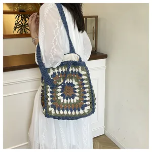 Close-up of ethnic crochet shoulder bag with geometric patterns and canvas lining detail