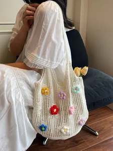 White crochet tote bag with colorful 3D flowers for summer beach vacations and floral style
