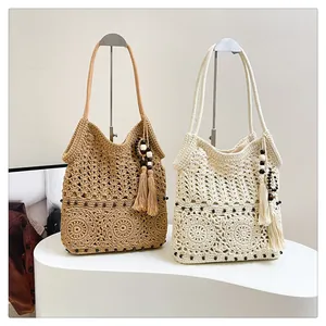 Detail of crochet weave pattern with wooden beads on handmade cotton shoulder bags