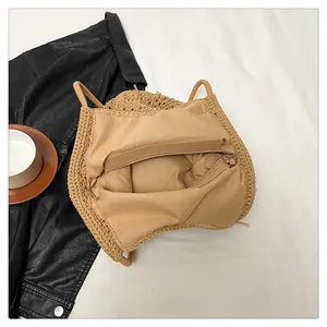 Detailed view of the hollow woven cotton shoulder bag with inner lining and zipper pocket