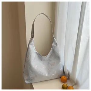 Detail of New Chinese style hobo bag with delicate butterfly embroidery and silver handles