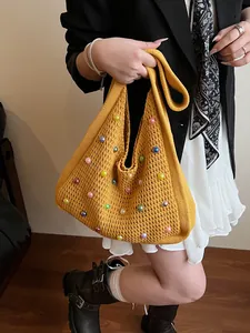 Yellow knit tote bag with colorful pearls and openwork crochet for summer holiday