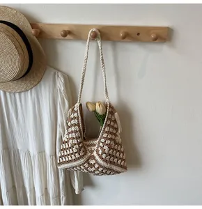 Detail of bohemian hand-woven crochet tote bag featuring fringe and geometric patterns