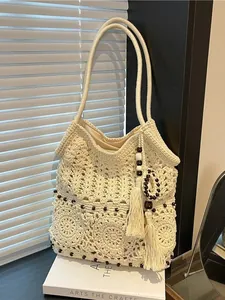 Bohemian beige crochet tote bag with wooden beads and tassels for summer beach travel