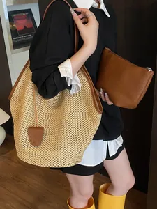 Large straw tote bag with brown leather trim and matching zippered pouch for beach or daily use