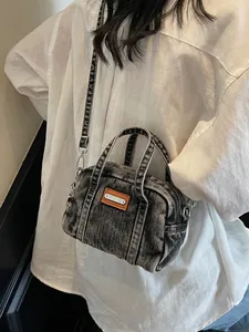 Retro washed denim bowling bag in dark grey with leather patch and adjustable shoulder strap