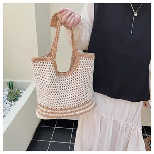 Detailed close-up of handmade hollow crochet tote bag with contrast woven texture