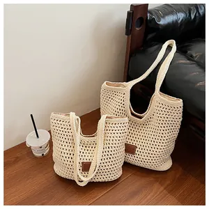 Detail of crochet knit tote bag showing woven texture and brown leather label