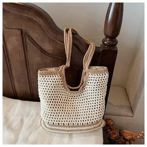 Close-up of a handmade crochet tote bag featuring beige and khaki hollow knit textures