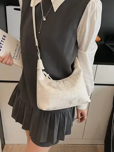 White crescent crossbody bag with rhinestones and ribbon detail for casual style