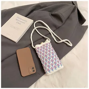 Detailed close-up of handmade tulip knitted phone crossbody bag with floral texture