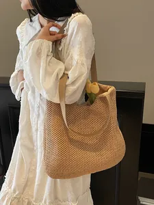 Minimalist straw woven tote bag in khaki with webbed handles for summer beach holidays