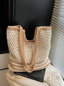 Chic beige and brown crochet tote bag with hollow woven texture for beach vacations